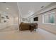 Finished basement with carpet, supports, mounted TV, and a window at 2340 S Columbine St, Denver, CO 80210