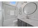 Bathroom with tub-shower combo, subway tile, skylight, and marble vanity at 2340 S Columbine St, Denver, CO 80210