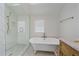 Bathroom featuring a claw foot tub, glass shower, and elegant finishes at 2340 S Columbine St, Denver, CO 80210