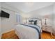 Cozy bedroom with plush bedding, shuttered windows, and classic bedside lamps at 2340 S Columbine St, Denver, CO 80210