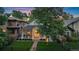 Charming home with a manicured lawn, covered porch, and mature trees, showcasing curb appeal at 2340 S Columbine St, Denver, CO 80210