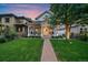 Inviting home with landscaped front yard, covered porch, and a charming pathway to the entrance at 2340 S Columbine St, Denver, CO 80210