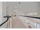 Bright hallway with carpet floors, black and white railings, and shuttered window at 2340 S Columbine St, Denver, CO 80210