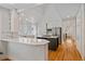Modern kitchen with white cabinets, stainless steel appliances, and an island with a cooktop at 2340 S Columbine St, Denver, CO 80210