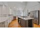 Bright kitchen with a center island, stainless steel appliances, and white cabinets, offering ample space at 2340 S Columbine St, Denver, CO 80210