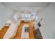 Bright kitchen featuring white cabinets, stainless steel appliances, island cooktop, and hardwood flooring at 2340 S Columbine St, Denver, CO 80210