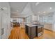 Open-concept kitchen with an island cooktop, white cabinets, and hardwood floors, perfect for entertaining at 2340 S Columbine St, Denver, CO 80210