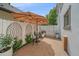 Charming brick patio area with an umbrella-covered table and chairs, perfect for outdoor dining and relaxation at 2340 S Columbine St, Denver, CO 80210