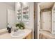 Bright bathroom with a vanity, shelves, and a mirror, providing a clean and functional space at 10700 Kimblewyck Cir # 155, Northglenn, CO 80233