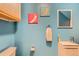 Stylish powder room with vibrant blue walls and trendy decor at 10700 Kimblewyck Cir # 155, Northglenn, CO 80233