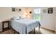 Comfortable bedroom featuring a queen-sized bed with a blue comforter and a bright window at 10700 Kimblewyck Cir # 155, Northglenn, CO 80233