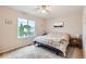 Bright main bedroom featuring carpet and a large window at 10700 Kimblewyck Cir # 155, Northglenn, CO 80233