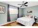Comfortable bedroom featuring a ceiling fan, large window, and bright natural light at 5190 E Asbury Ave, Denver, CO 80222