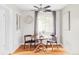 Charming dining area with a modern ceiling fan, round wood table, and a window with natural light at 5190 E Asbury Ave, Denver, CO 80222