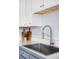 Modern kitchen sink features updated faucet and a bright countertop space at 5190 E Asbury Ave, Denver, CO 80222