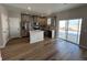 Modern kitchen with island, stainless steel appliances, and gray cabinets at 9456 Yampa Ct, Commerce City, CO 80022