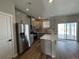 Modern kitchen with island, stainless steel appliances, and gray cabinets at 9456 Yampa Ct, Commerce City, CO 80022