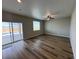 Living room with vinyl plank flooring and sliding door to patio at 9456 Yampa Ct, Commerce City, CO 80022