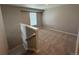 Bright loft area with carpeted floor and staircase at 9456 Yampa Ct, Commerce City, CO 80022