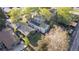 Aerial shot of a home's backyard with a lush lawn, fencing, patio, solar panels, and neighborhood treeline at 1248 Meadow St, Longmont, CO 80501