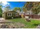 Private fenced backyard featuring brick fire pit, storage shed, and mature landscaping at 1248 Meadow St, Longmont, CO 80501