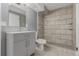 Nicely updated bathroom with large walk-in shower, tiled walls, and grey vanity at 1248 Meadow St, Longmont, CO 80501