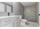 This updated bathroom features new cabinets and a tiled shower at 1248 Meadow St, Longmont, CO 80501