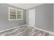 This bedroom features wood floors, a gray accent wall, and a double-hung window at 1248 Meadow St, Longmont, CO 80501