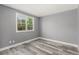 This bedroom has wood floors, white trim, and a double window at 1248 Meadow St, Longmont, CO 80501