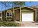 Green single-Gathering home with a white garage door, complimented by lush grass at 1248 Meadow St, Longmont, CO 80501