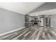Open living space with new floors, gray walls and an adjacent kitchen area at 1248 Meadow St, Longmont, CO 80501