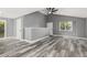 Open-concept living space featuring gray walls, high ceilings, modern fan, and wood-style floors at 1248 Meadow St, Longmont, CO 80501