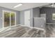Living room with sliding glass doors, wood floors, and new gray paint at 1248 Meadow St, Longmont, CO 80501