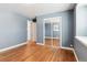 Bedroom with hardwood floors and mirrored closet at 11418 Fowler Dr, Northglenn, CO 80233