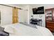 Main bedroom with a sliding barn door and a workspace at 8367 S Reed St # A1, Littleton, CO 80128