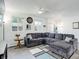 Bright living room featuring a sectional sofa and decorative rug at 8367 S Reed St # A1, Littleton, CO 80128