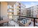 Condo balcony with seating and views of the community pool and amenity deck at 20 Wilcox # 421, Castle Rock, CO 80104