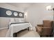 This bedroom features a queen bed, accent wall and round decorative mirrors at 20 Wilcox # 421, Castle Rock, CO 80104