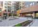 Apartment exterior featuring modern architecture, community entrance, and landscaped courtyard with seating at 20 Wilcox # 421, Castle Rock, CO 80104