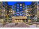 Modern apartment complex featuring string lights and brick facade at twilight at 20 Wilcox # 421, Castle Rock, CO 80104