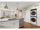 Bright kitchen with island, stainless steel appliances, and stacked washer/dryer at 20 Wilcox # 421, Castle Rock, CO 80104