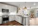 Modern kitchen with white cabinets, stainless appliances, and open layout to living area at 20 Wilcox # 421, Castle Rock, CO 80104