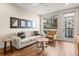 Bright living room featuring wood floors, modern furniture, and large windows with city views at 20 Wilcox # 421, Castle Rock, CO 80104