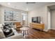 Cozy living room with hardwood floors, modern furniture, and a large window at 20 Wilcox # 421, Castle Rock, CO 80104