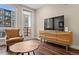 Cozy living room featuring a TV, balcony access, and comfortable seating at 20 Wilcox # 421, Castle Rock, CO 80104