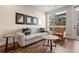 Bright living room with wood floors, stylish furniture, and views of the city at 20 Wilcox # 421, Castle Rock, CO 80104