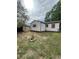 Backyard with detached single story structure featuring white siding and brown accents at 2625 W Ellsworth Ave, Denver, CO 80219