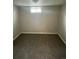 An empty carpeted basement bedroom with small window at 2625 W Ellsworth Ave, Denver, CO 80219