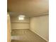 A small unfinished room in the basement with carpet and a small window at 2625 W Ellsworth Ave, Denver, CO 80219
