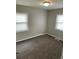Inviting bedroom featuring neutral walls, plush carpeting, and two bright, sunlit windows at 2625 W Ellsworth Ave, Denver, CO 80219